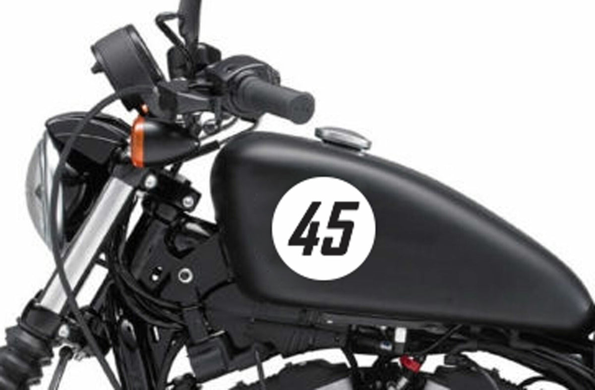Race number roundel decal on a black motorcycle tank