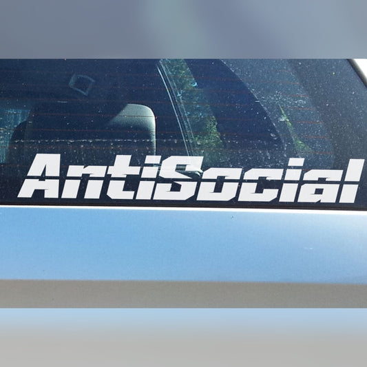 Antisocial decal – bold white lettering on the rear window of a silver car