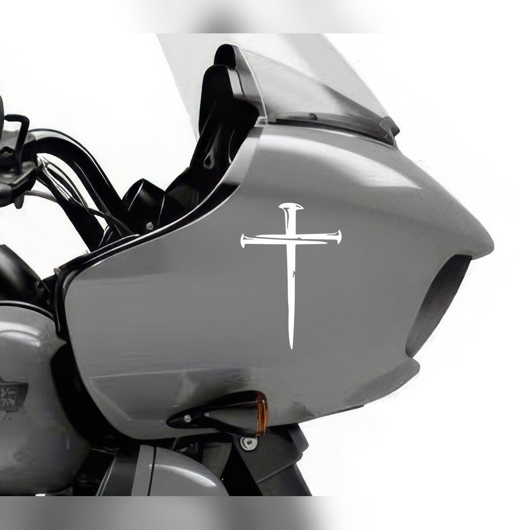 Cross decal – white nail cross on the grey fairing of a motorcycle