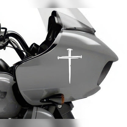 Cross decal – white nail cross on the grey fairing of a motorcycle