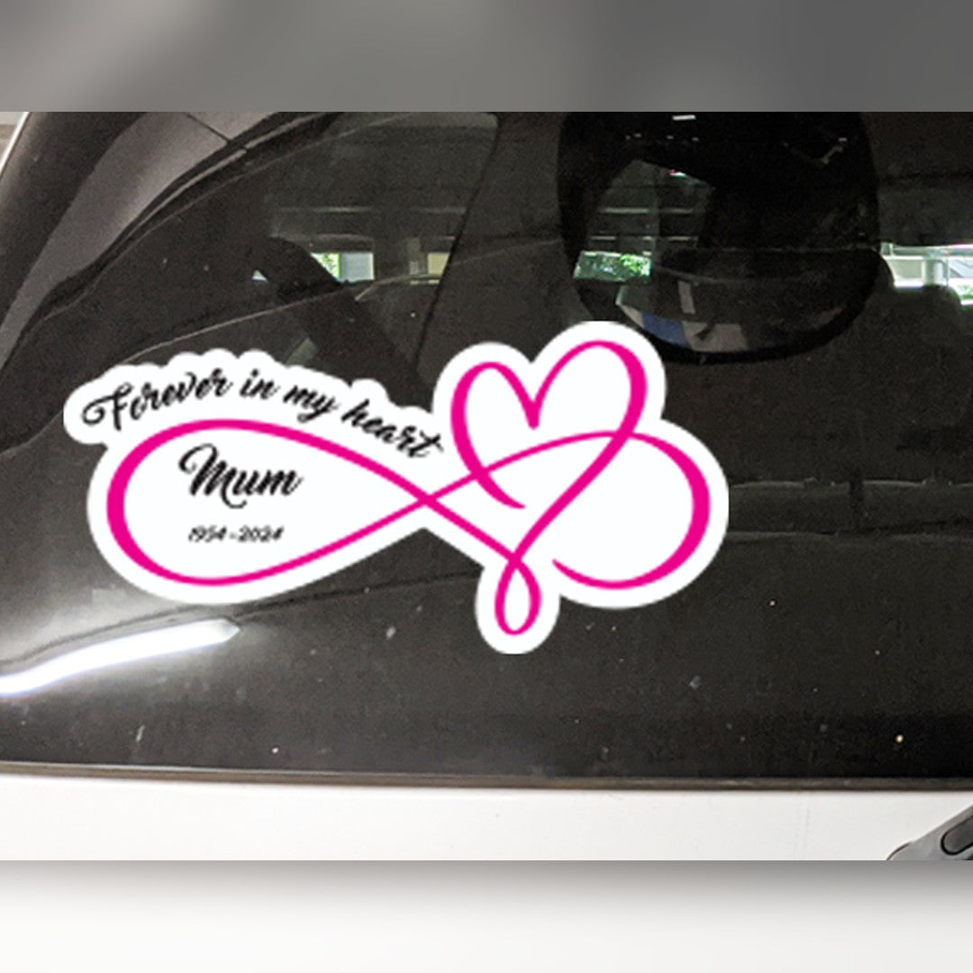 Memorial car decal – pink infinity heart with Forever in my heart, Mum and 1954-2024 in black script on a car window
