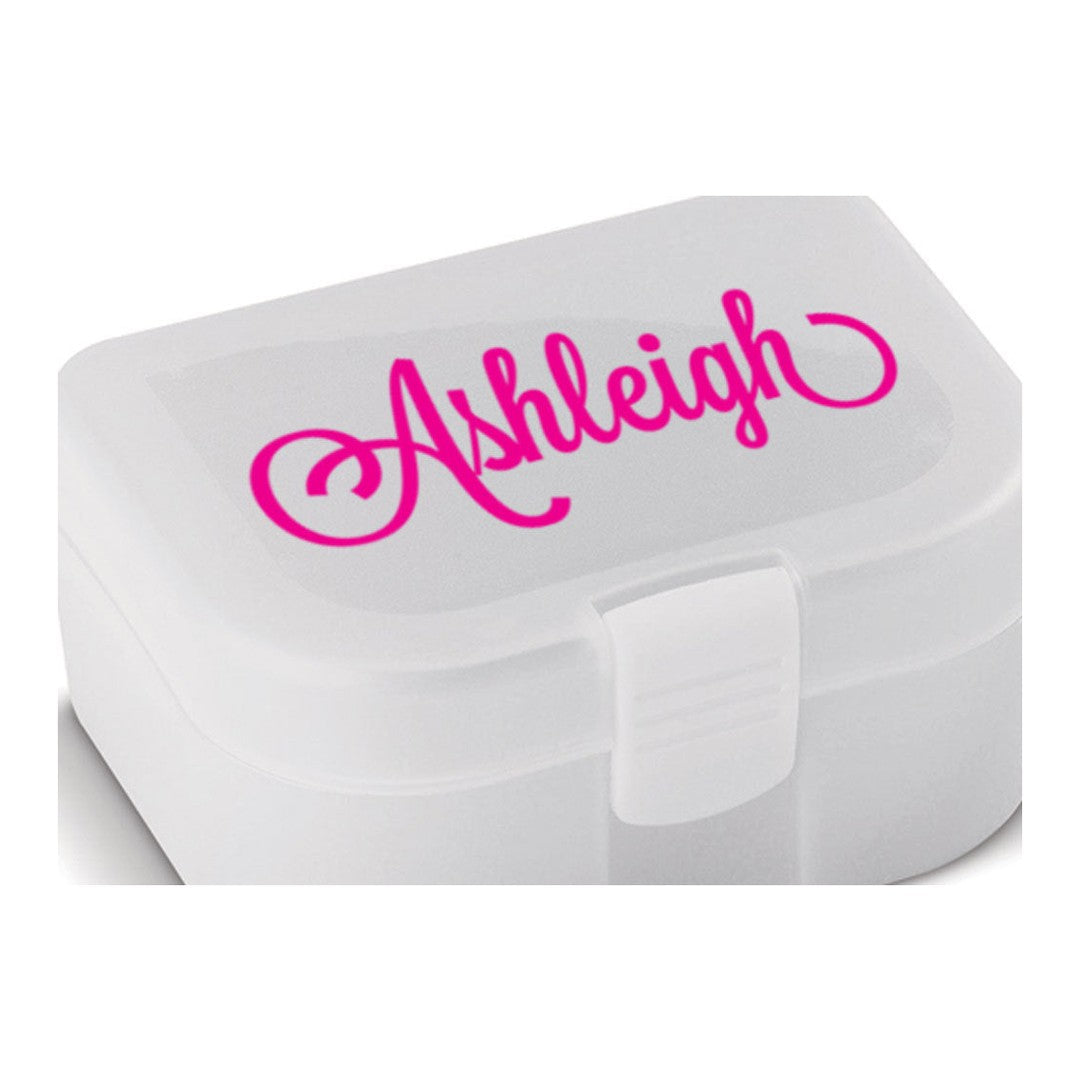 Name sticker – hot pink script name Ashleigh on the lid of a small white plastic lunch box