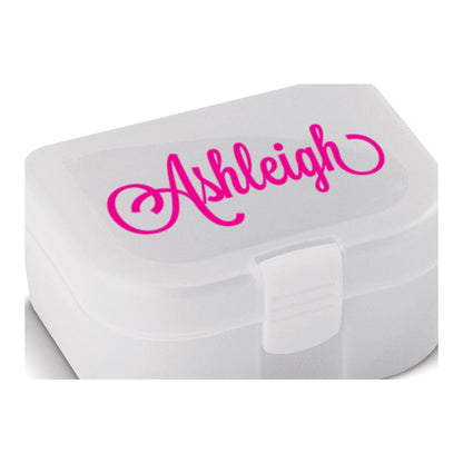Name sticker – hot pink script name Ashleigh on the lid of a small white plastic lunch box