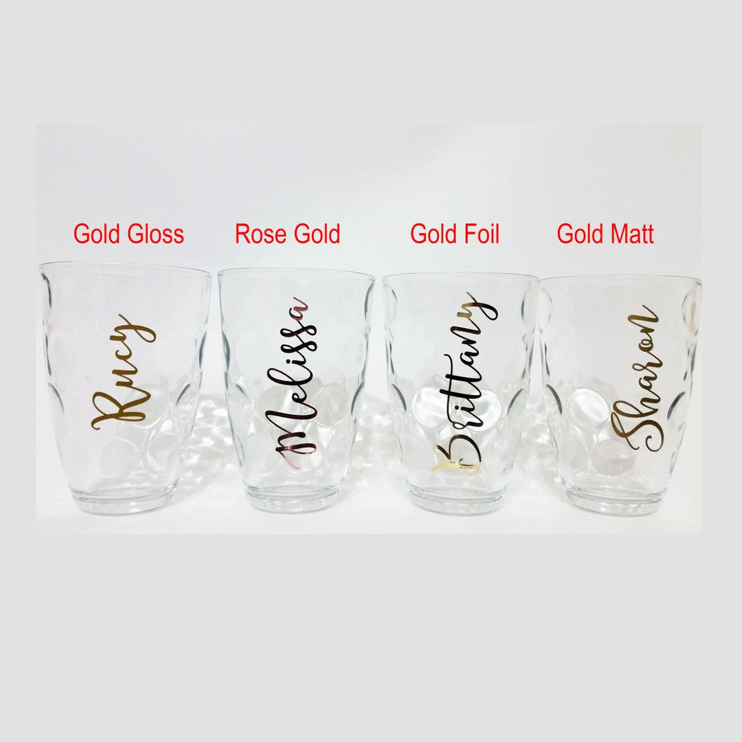 Wine glass name decal – gold gloss, rose gold, gold foil and gold matt names on four clear glasses