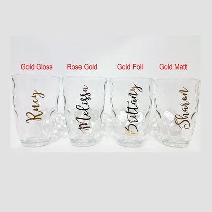 Wine glass name decal – gold gloss, rose gold, gold foil and gold matt names on four clear glasses