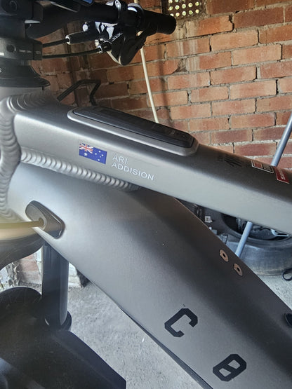 Australian flag and name sticker in block capitals applied to a silver bicycle frame